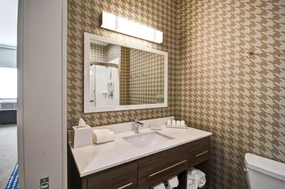 a bathroom with a sink and a mirror at Home2 Suites By Hilton Columbus Downtown in Columbus