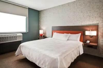 a hotel room with a large bed and a window at Home2 Suites By Hilton Columbus Downtown in Columbus