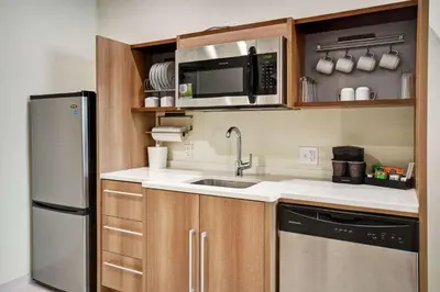 a small kitchen with a sink and a microwave at Home2 Suites By Hilton Columbus Downtown in Columbus