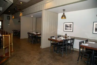 a dining room with wooden tables and chairs at The Stables Inn & Suites in Salem