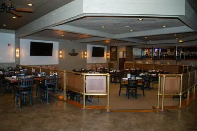 a restaurant with tables and chairs in a room at The Stables Inn & Suites in Salem