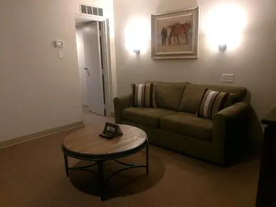 a living room with a couch and a table at The Stables Inn & Suites in Salem