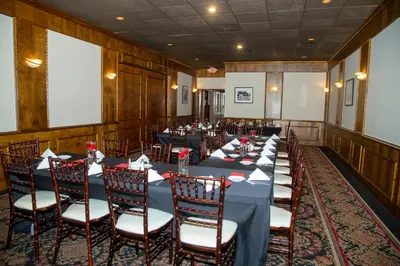a conference room with long tables and chairs at The Stables Inn & Suites in Salem