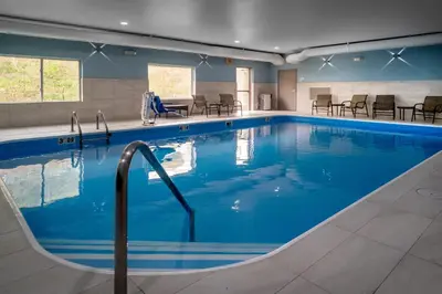 a large pool with blue water in a hotel room at Holiday Inn Express - Charleston/Kanawha City by IHG in Charleston
