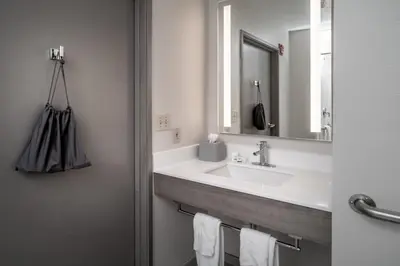 a bathroom with a sink and a mirror at Holiday Inn Express - Charleston/Kanawha City by IHG in Charleston