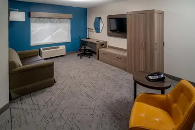 a living room with a couch and a desk at Holiday Inn Express - Charleston/Kanawha City by IHG in Charleston