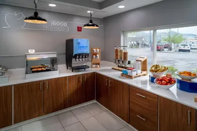a kitchen with wooden cabinets and a large window at Holiday Inn Express - Charleston/Kanawha City by IHG in Charleston