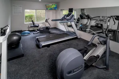 a gym with treadmill and ellipticals in a room at Holiday Inn Express - Charleston/Kanawha City by IHG in Charleston