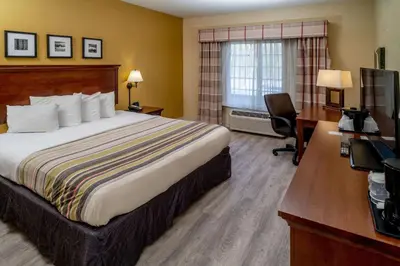 a hotel room with a bed and a desk at Country Inn & Suites By Radisson, Charleston South, WV in Charleston