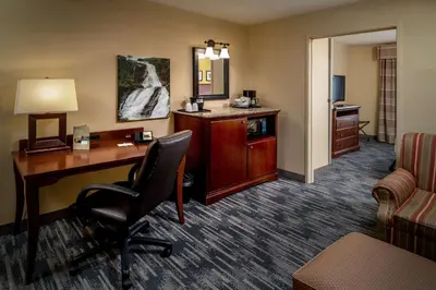 a hotel room with a desk and a chair at Country Inn & Suites By Radisson, Charleston South, WV in Charleston