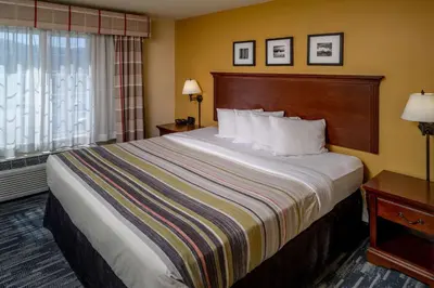 a hotel room with a large bed and a window at Country Inn & Suites By Radisson, Charleston South, WV in Charleston