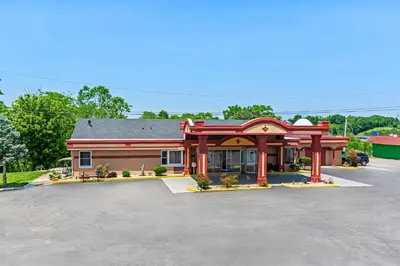 a building with a parking lot in front of it at Americas Best Value Inn & Suites Williamstown in Williamstown