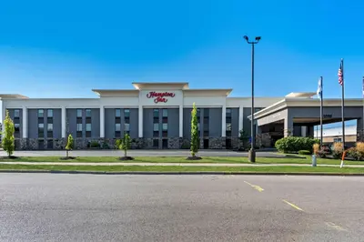 a large white building with a sign on it at Hampton Inn Dayton/Huber Heights in Huber Heights