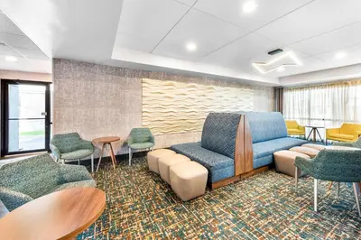 a waiting room with a blue couch and chairs at Hampton Inn Dayton/Huber Heights in Huber Heights