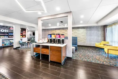 a lobby of a store with a counter and chairs at Hampton Inn Dayton/Huber Heights in Huber Heights