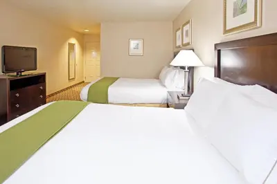 a hotel room with two beds and a flat screen tv at Holiday Inn Express & Suites Columbus East - Reynoldsburg by IHG in Reynoldsburg