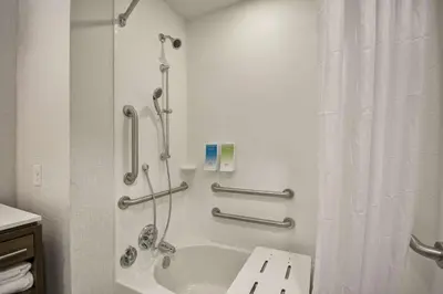 a bathroom with a shower and a tub and a sink at Home2 Suites By Hilton Blue Ash Cincinnati in Blue Ash