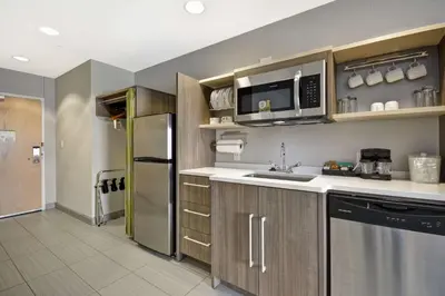 a kitchen with a sink and a refrigerator at Home2 Suites By Hilton Blue Ash Cincinnati in Blue Ash