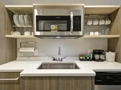 a kitchen with a sink and a microwave at Home2 Suites By Hilton Blue Ash Cincinnati in Blue Ash