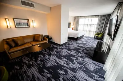 a hotel room with a couch and a bed at Fairfield by Marriott Inn & Suites Washington Casino Area in Washington