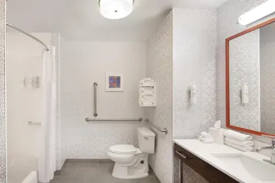 a bathroom with a toilet and a sink and a mirror at Hampton Inn & Suites Cleveland-Mentor in Mentor