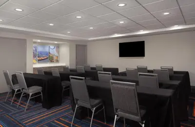 a conference room with black tables and chairs and a flat screen tv at Hampton Inn & Suites Cleveland-Mentor in Mentor