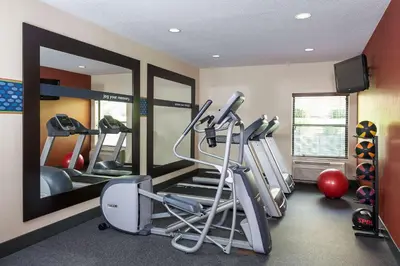 a gym with tread machines and a mirror at Hampton Inn Mansfield/Ontario in Mansfield