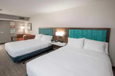 a hotel room with two beds and a desk at Hampton Inn Dry Ridge in Dry Ridge