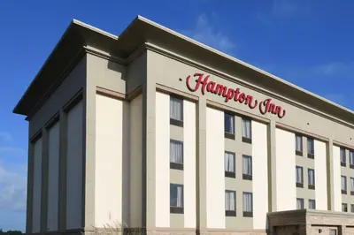 a building with a sign on the side of it at Hampton Inn Dry Ridge in Dry Ridge