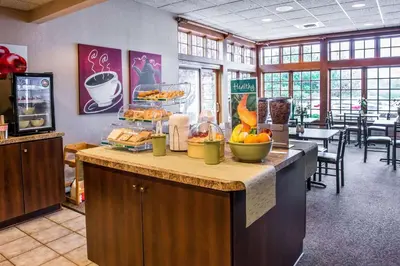 a restaurant with a counter with food on it at Quality Inn Pittsburgh Airport in Oakdale