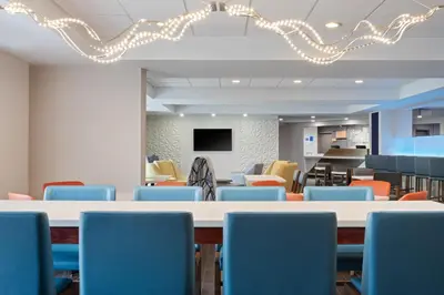 a conference room with a table and chairs at Holiday Inn Express & Suites Cincinnati Riverfront by IHG in Covington