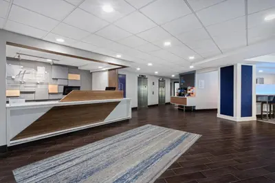 an empty lobby of an office building with a kitchen at Holiday Inn Express & Suites Cincinnati Riverfront by IHG in Covington