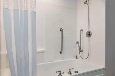 a bath tub with a shower curtain in a bathroom at Hampton Inn Greenfield in Greenfield
