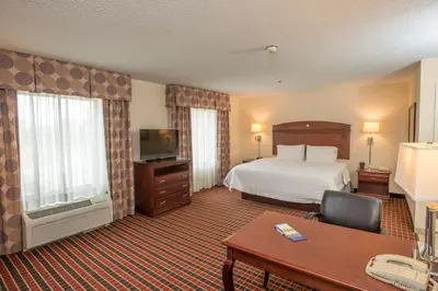 a hotel room with a bed and a desk at Hampton Inn & Suites Dayton-Airport in Englewood