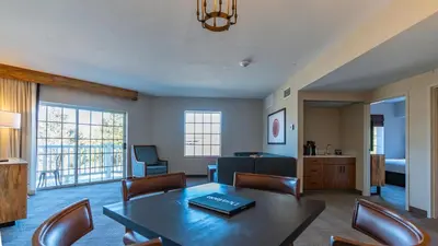 a living room with a table and a couch at Cherry Valley Hotel in Newark