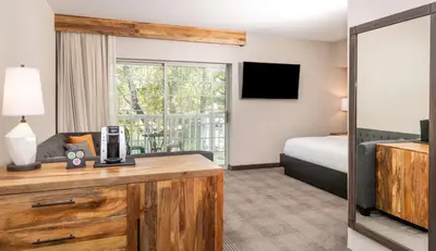 a hotel room with a bed and a television at Cherry Valley Hotel in Newark