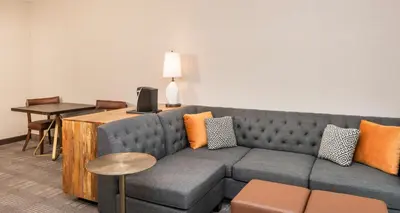 a living room with a couch and a table at Cherry Valley Hotel in Newark