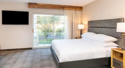a bedroom with a bed and a large window at Cherry Valley Hotel in Newark