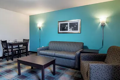 a living room with a couch and a table at Suburban Studios Monaca - Pittsburgh in Monaca