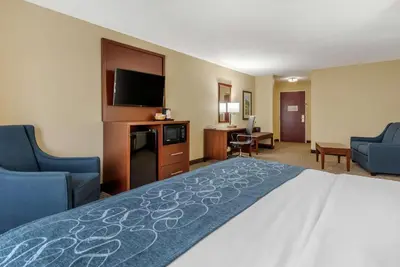 a hotel room with a bed and a flat screen tv at Comfort Suites Dayton-Wright Patterson in Dayton