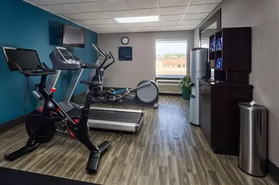 a gym with a treadmill and a exercise bike in a room at Hampton Inn Massillon in Massillon