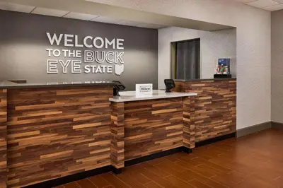 a welcome to the buckeye store with a reception desk at Hampton Inn Massillon in Massillon