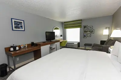 a hotel room with a bed and a desk at Hampton Inn Youngstown-North in Youngstown