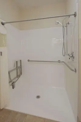 a white bathroom with a shower with a shower curtain at Hampton Inn Youngstown-North in Youngstown