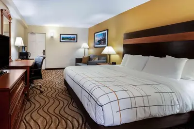a hotel room with a large bed and a desk at La Quinta Inn by Wyndham Sandusky near Cedar Point in Sandusky