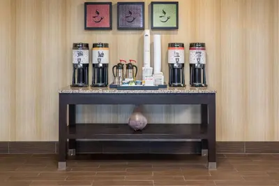 a table with a group of bottles on it at Hampton Inn Parkersburg/Mineral Wells in Mineralwells