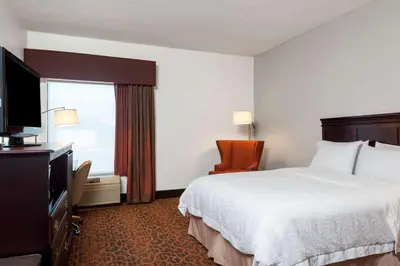 a hotel room with a bed and a television at Hampton Inn Parkersburg/Mineral Wells in Mineralwells
