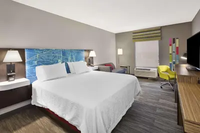 a hotel room with a bed and a flat screen tv at Hampton Inn & Suites Springboro in Springboro