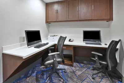 an office with two computers on a desk with chairs at Hampton Inn & Suites Springboro in Springboro