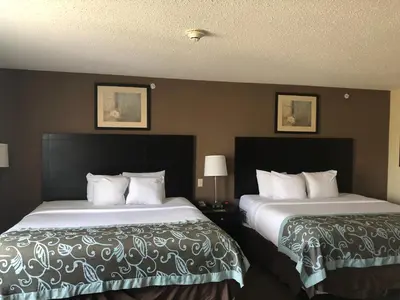 two beds in a hotel room next to each other at Wingate by Wyndham Erlanger - Florence - Cincinnati South in Erlanger
